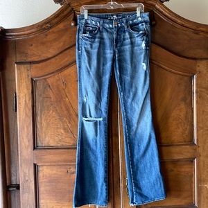 Distressed medium wash boot cut jeans